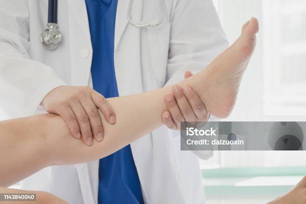 Doctor Giving A Patient A Leg Treatment Stock Photo - Download Image Now - Adult, Adults Only, Alternative Therapy