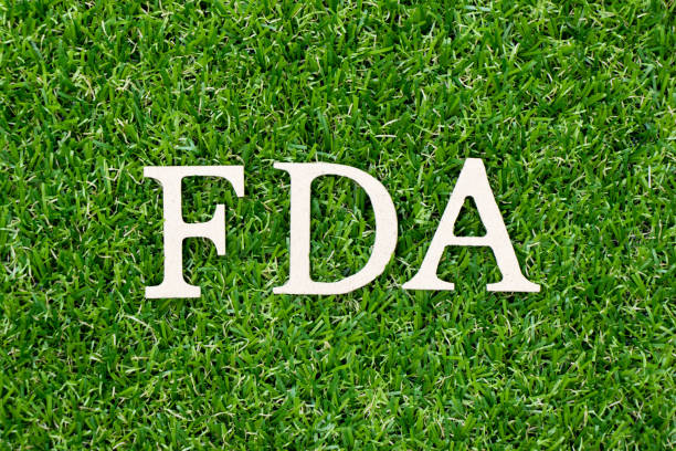 Wood letter block in word FDA (abbreviation of food and drug administration) on artificial green grass background Wood letter block in word FDA (abbreviation of food and drug administration) on artificial green grass background food and drug administration stock pictures, royalty-free photos & images