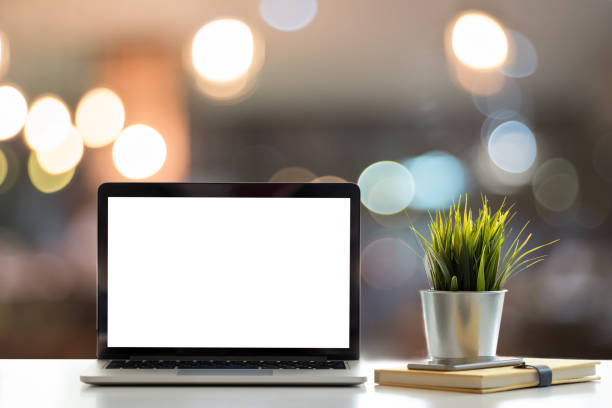 istock Laptop with blank screen on table. coffee shop blurred background. 1143845344