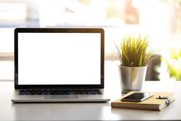 istock Laptop with blank screen on table. coffee shop blurred background. 1143845351