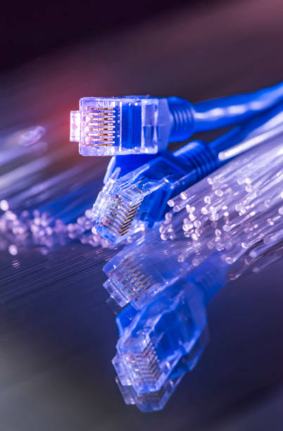 istock Network cable with high tech technology Fiber optical color background 1143849530