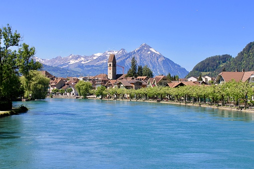 Interlaken, Switzerland - May 11, 2018: Old town Interlaken was established around the 14th century. The town grew around the mill that was built there prior to the year 1365. Today when visitors walk around they can still see the original buildings from the town that date back hundreds of years.