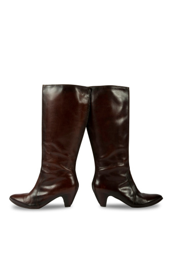 Female brown leather high heel boots, isolated on a white background. Clipping path included.
