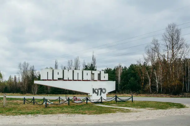 Photo of Pripyat , Ukraine - APRIL 15, 2019 : sign welcoming visitors of Chernobyl city, Dead city Pripyat. Chernobyl now touristic attraction in popular Chernobyl tours (Translation of text in cyrilics: Pripyat)
