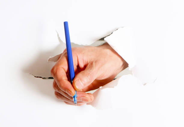 istock A man's hand holds a ballpoint pen. 1143859948