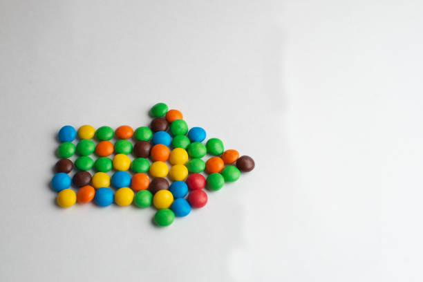 Arrow from rainbow balls on a blue background.