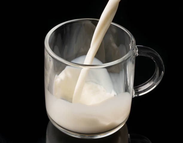 istock pouring milk into glass 1143861208