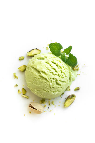 Pistachio Ice Cream Pistachio Ice Cream isolated on white background, top view. Green pistachio gelato with pistachio nuts and mint. gelato stock pictures, royalty-free photos & images