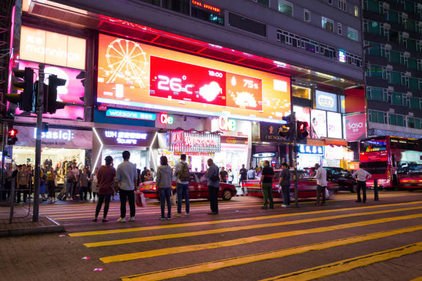 tsim sha tsui, hong kong-07 novembre, 2018: les gens marchent dans le quartier de tsim sha tsui. tsim sha tsui est l’une des principales zones commerçantes de hong kong. - hong shopping night skyline photos et images de collection