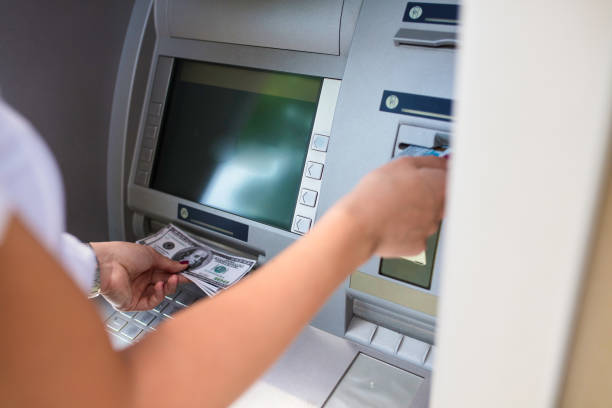 istock Woman withdrawing money from ATM 1143868688