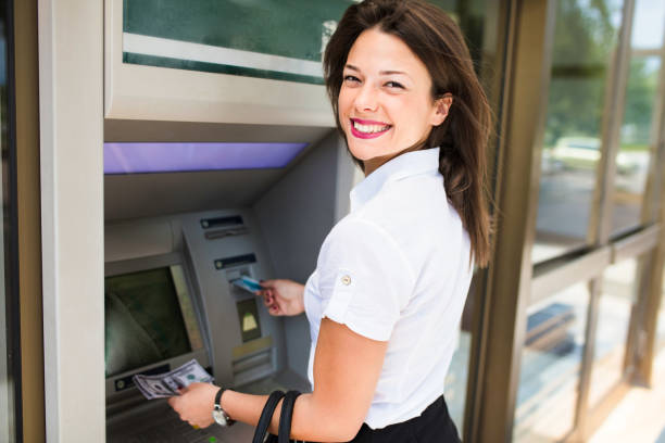 istock Woman withdrawing money from ATM 1143868770