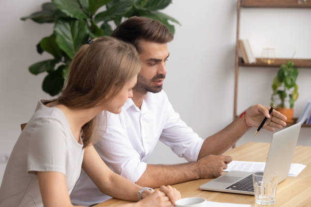 istock Businessman, mentor and trainee working on project together, using laptop 1143869373