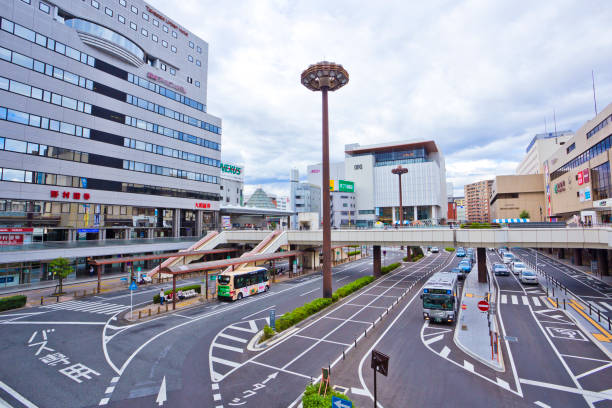 Downtown Takasaki Japan Central town square with train station Takasai, Japan - October 2018 : Takasaki station is the biggest station in Gumma prefecture. There are many local buses and taxis radiating out from the train station gunma prefecture stock pictures, royalty-free photos & images