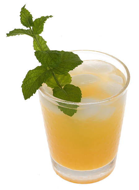 istock Fresh Orange Juice with Cut Oranges, Straws, Mint Garnish, Isolated 114387242