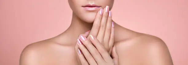 Beauty Woman with perfect Makeup and Manicure. Glamour Girl. Pink Lips and Nails. Skin care foundation. Beauty girls Face isolated on light Background. Fashion photo