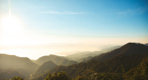 istock Mountain landscape panorama view with bright blue sky and sun causing lens flare., blue sky background with tiny clouds 1143874654