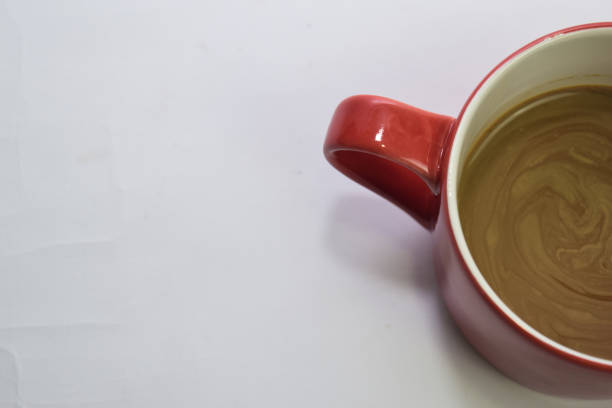 istock Close up hot cappuccino coffee in a red cup isolated on a white background 1143876056
