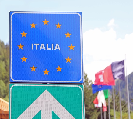 Road signal on the Italian border with many yellow stars of European Union