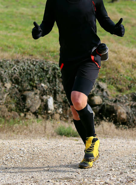 istock runner during cross-country race with thumbs upwards 1143880362