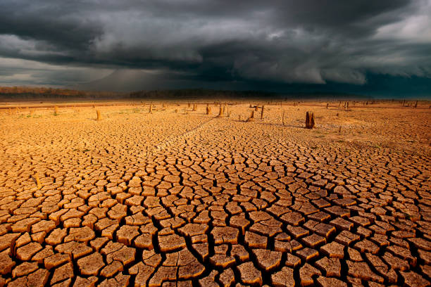 istock thunder storm sky Rain clouds  Cracked dry land without wate 1143882725