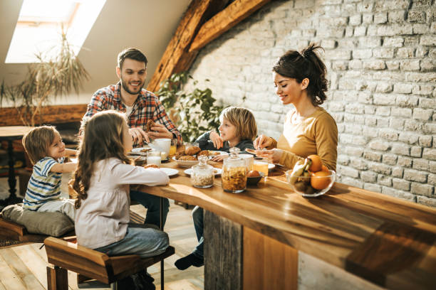 istock Young happy family enjoying while having a meal in dining room. 1143889572