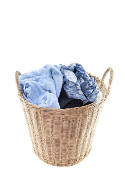 istock Clothes in a laundry wooden basket isolated on white background. Clipping path. 1143889924