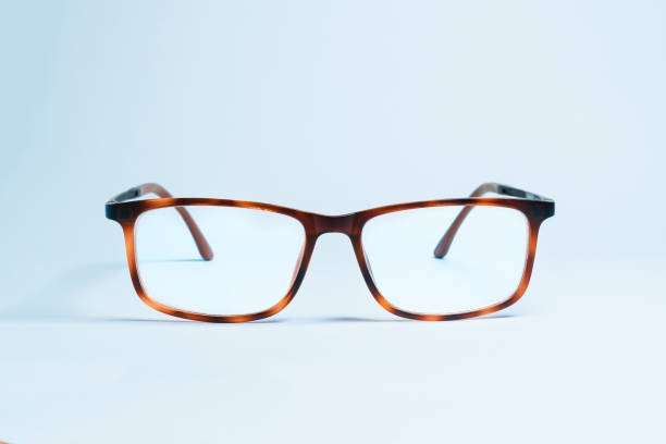 A pair of elegant and classic eyeglasses with thick and vintage frames on a uniform white background