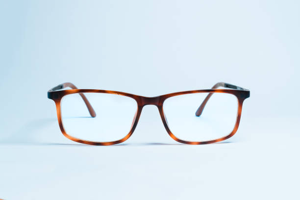 A pair of elegant and classic eyeglasses with thick and vintage frames on a uniform white background stock photo