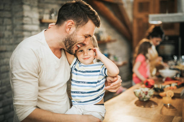istock Happy father and son showing affection in the kitchen. 1143891810
