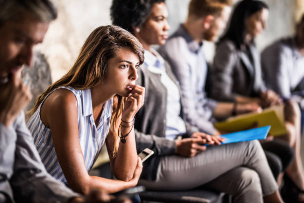 istock Young businesswoman feeling worried while waiting for job interview. 1143894355