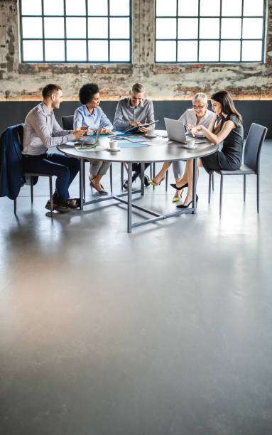 istock Happy business team cooperating on a meeting at the table. 1143894376