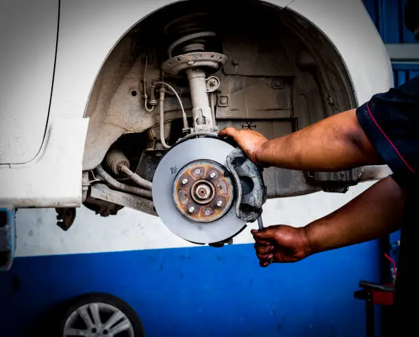 Photo of Brake lathe tool polishing disc brakes of cars working automatic