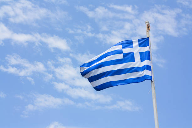 istock Greek flag with bright sky background 1143895249
