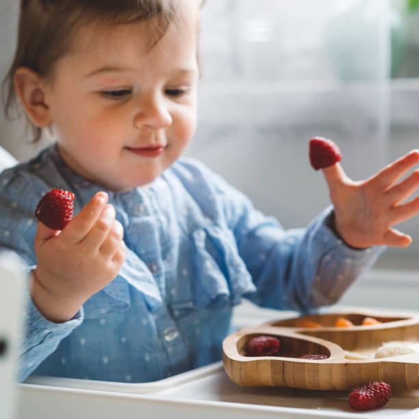 istock Baby amazed by raspberries 1143897637