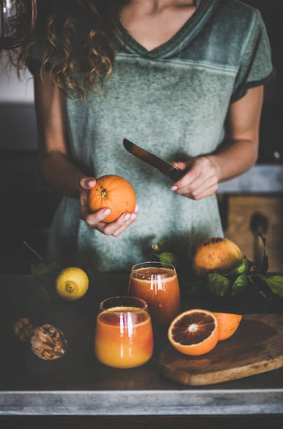 istock Woman making fresh blood orange juice or smoothie 1143897648