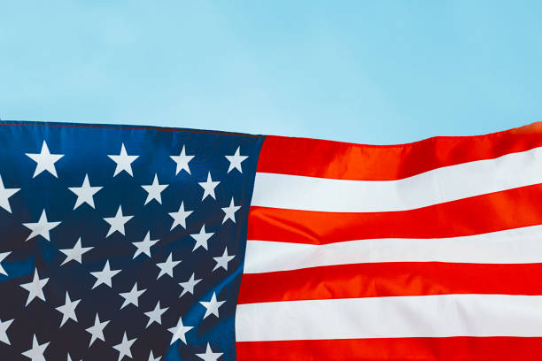 istock big american flag on blue background 1143898854
