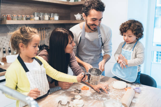 istock Family making cookies in kitchen 1143900098