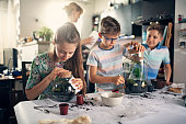 Family enjoying making plant bottle gardens