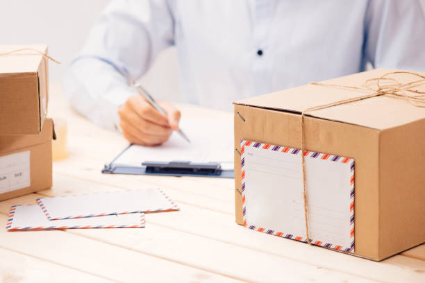 istock Delivery concept. Man signs papers among parcels 1143904966