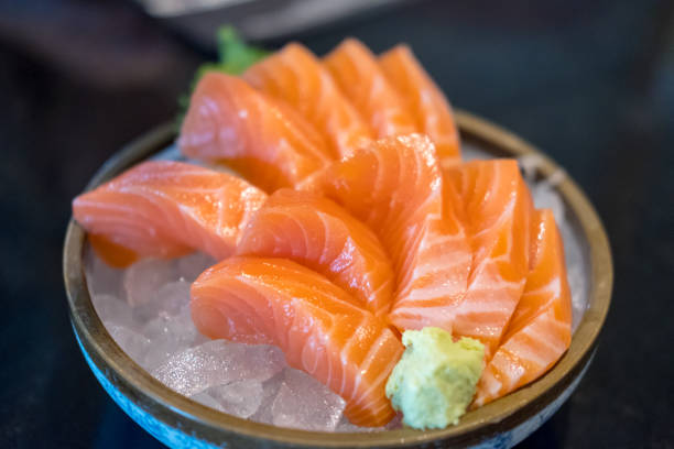 istock Salmon sashimi with vegetable and ice in a bowl, served in a restaurant 1143905246