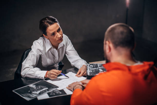 istock Woman detective interrogating a man prisoner in interrogation room 1143905912