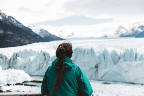istock Woman looking at Perito Moreno glacier and mountains 1143906775