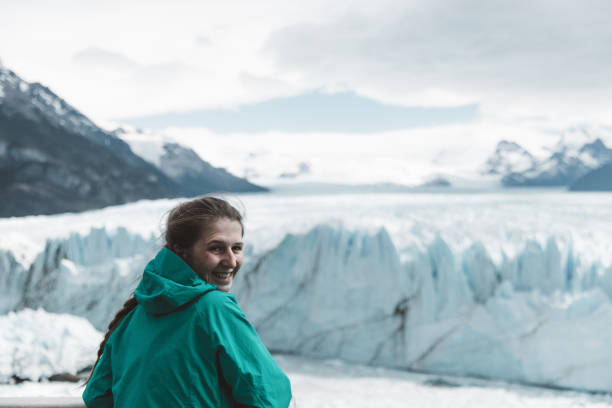 istock Woman looking at Perito Moreno glacier and mountains 1143909150