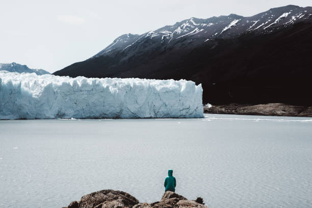 istock Woman looking at glacier Perito Moreno 1143909279