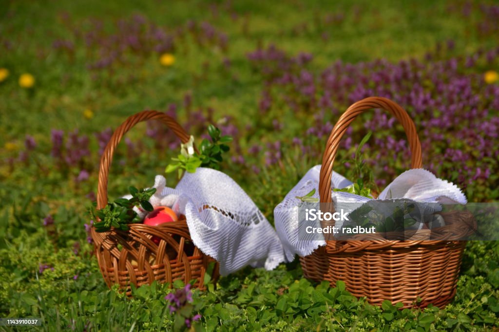 Easter baskets against the background of grass and flowers. Easter baskets on a background of grass and flowers. Animal Egg Stock Photo