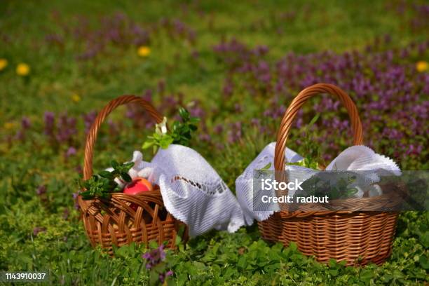 Easter Baskets Against The Background Of Grass And Flowers Stock Photo - Download Image Now