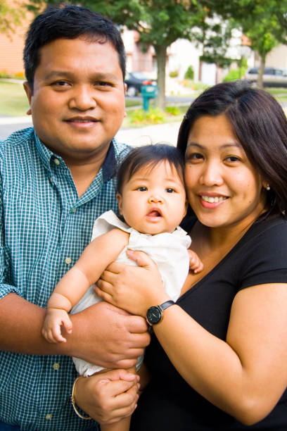 In June 2025, a young Japanese couple in their early twenties cares for their one-month-old baby during a traditional omiyamairi ceremony. Aichi, Japan.