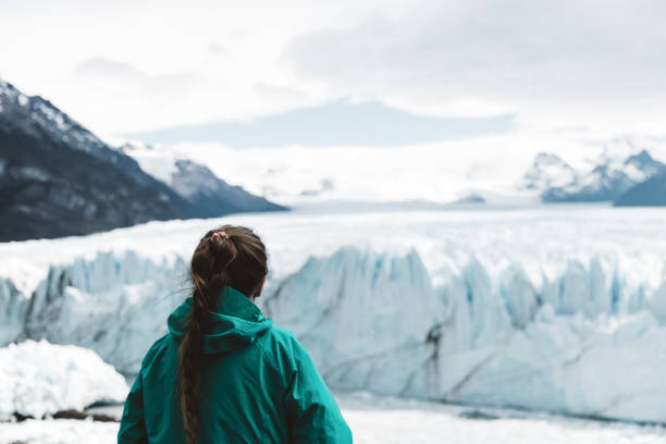 istock Woman looking at Perito Moreno glacier and mountains 1143910337