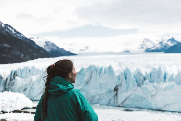 istock Woman looking at Perito Moreno glacier and mountains 1143910606