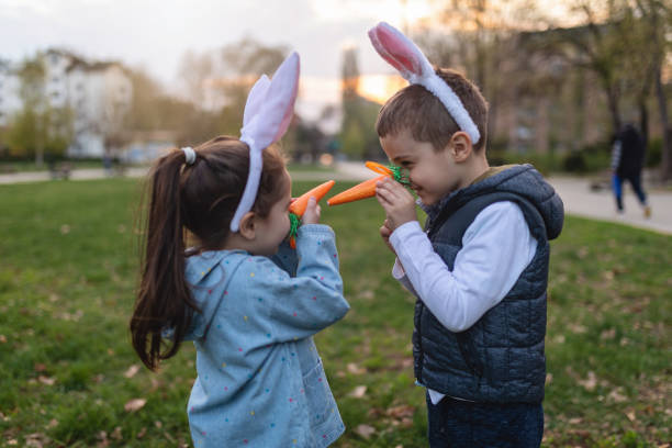 istock Joyful brother and sister playing around in park 1143910748